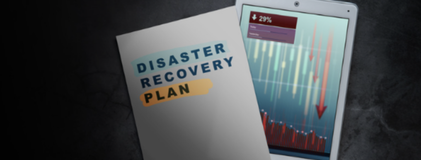 A close-up image of a disaster recovery plan document next to a tablet showing a declining graph, symbolizing the critical role of "backup and disaster recovery" in safeguarding business data and ensuring continuity during disruptions.